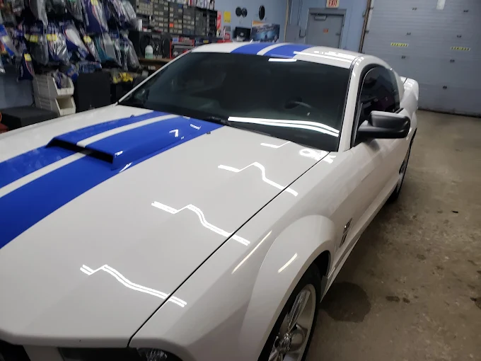 White Ford Mustang custom audio and lighting